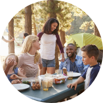 Group of people sharing a meal at a camping site