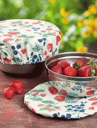 Strawberries in steel bowl with reusable bowl cover