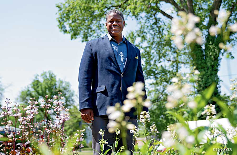 An image of Pastor Kip Banks standing among flowers.
